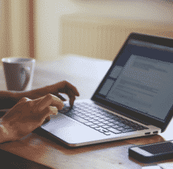 woman looking at computer financial documents