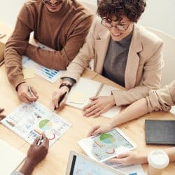 woman at a meeting table going over financial documents