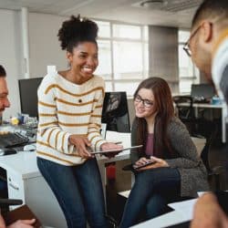 Young woman presenting her idea to colleagues using her iPad