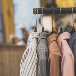 A clothes rack with women's coats hanging on it