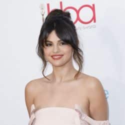Selena Gomez smiling at the camera at a red carpet event