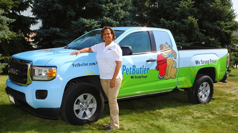 Rebecca Stewart stands outside in front of her Pet Butler work vehicle