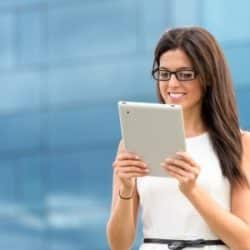 young woman on tablet outside