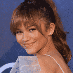 Zendaya poses with head looking over shoulders smiling