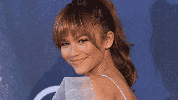 Zendaya poses with head looking over shoulders smiling
