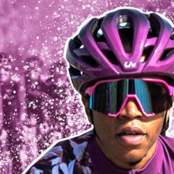 Ayesha McGowan wearing a purple helmet and purple glasses for cycling in front of a purple graphic of cyclists
