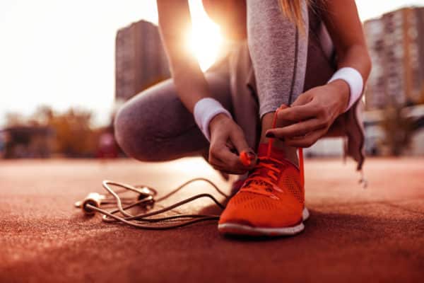 Image of the lower half of a Woman who is preparing for jogging