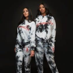Vanessa Bryant and her eldest daughter wearing the tie dye sweat suit set for MAMBACITA clothing while standing in front of an all black background