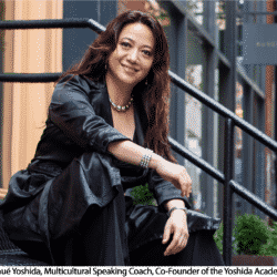 Woman in black jacket and pants smiling sitting on stairs