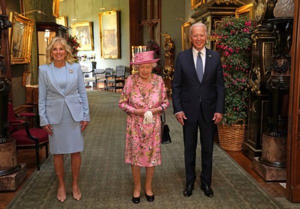 Joe Biden and Dr. Jill Biden walking through the palace with Queen Elizabeth