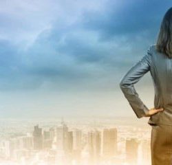 business woman looking at silhoutte landscpae of big city