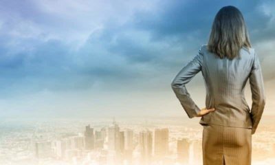 business woman looking at silhoutte landscpae of big city