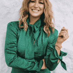 Fitness Trainer Karena Dawn smiling at the camera in a green silk button up shirt