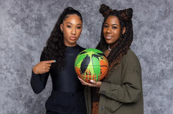 Jasmine Jordan and peer holding up a basketball
