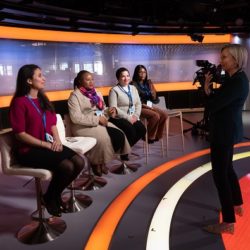 four professional woman on a panel board with woman photographer