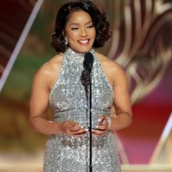 Angela Bassett in sparkling silver dress talking on stage
