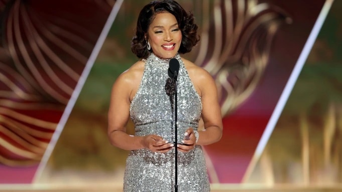 Angela Bassett in sparkling silver dress talking on stage