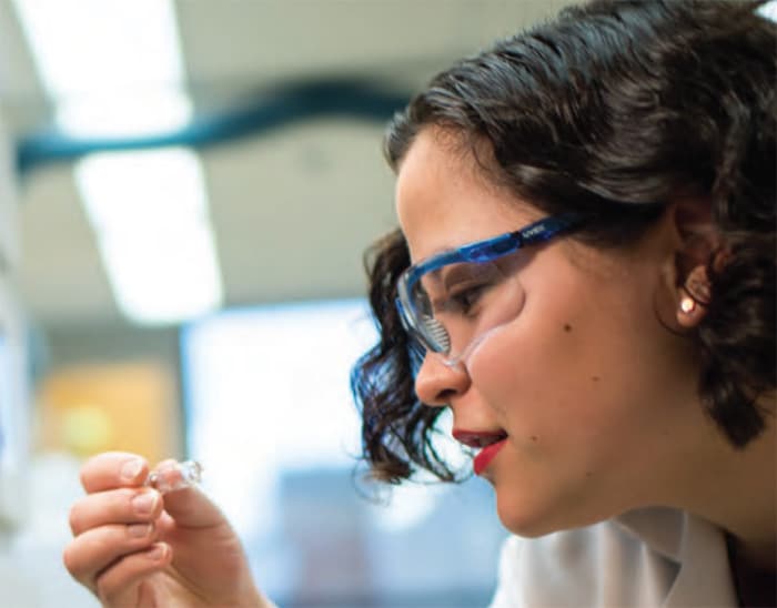 woman scientist looking at test tube