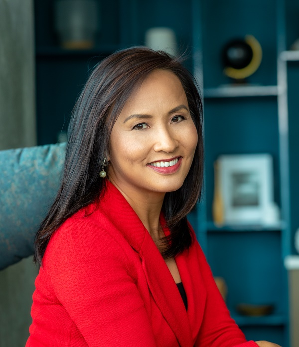 Ying McGuire smiling wearing red blazer