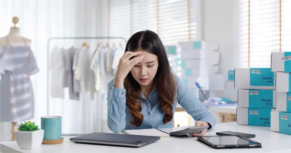 woman business owner studying financials at desk