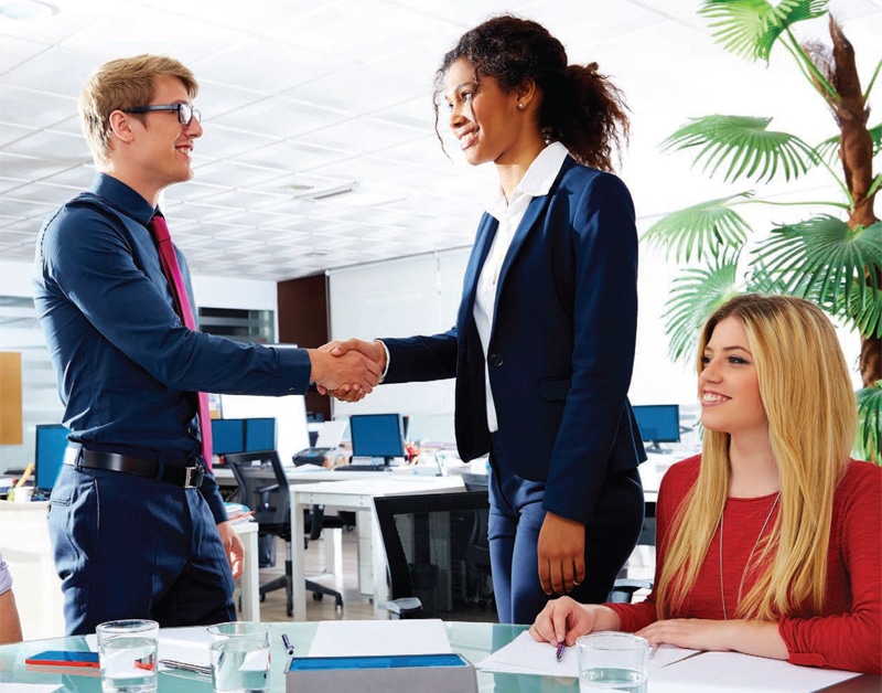 woman shaking hands with hiring manager
